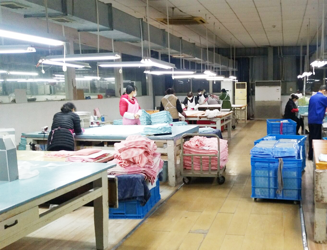 Workers assembling bamboo hoodies on production line