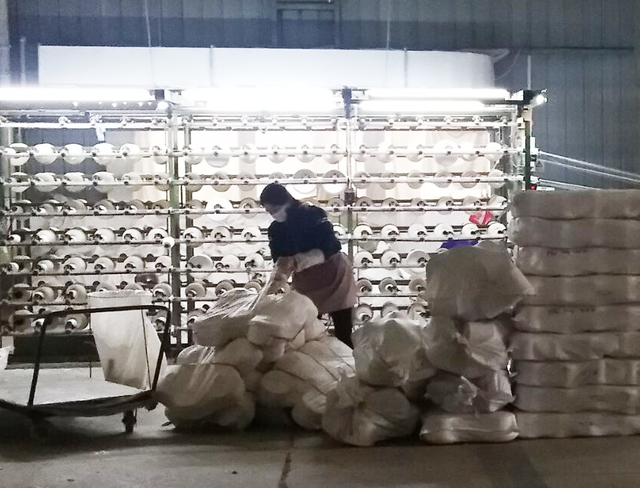 Factory workers assembling eco-friendly bamboo clothing